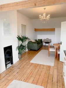 a living room with a couch a table and a fireplace at Escape to Lytham St. Annes in Lytham St Annes