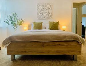 a large bed in a bedroom with two lamps at Escape to Lytham St. Annes in Lytham St Annes +14 photos