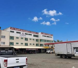 a white truck parked in front of a building at Augustos Hotel in Santo Antônio de Jesus
