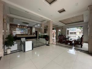a large lobby with a television in a building at SEAMOON Hotel in Rạch Giá