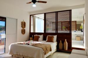 a bedroom with a large bed with flowers on it at Mareias Villas in São Miguel do Gostoso