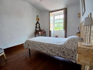 a bedroom with a bed and a window at Esposende Garden in Esposende