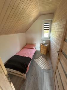 a small bedroom with a bed in a attic at Noclegi Dąbek in Rymanów +14 photos