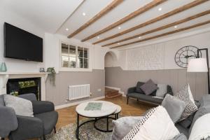 a living room with a couch and a fireplace at Lion Cottage - Dog-Friendly 3-Bed in Heart of Holt in Holt +31 photos