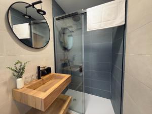 a bathroom with a wooden sink and a mirror at Apartamentos La Búsqueda in Cuenca +26 photos
