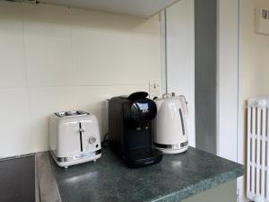 a kitchen counter with two coffeemakers on it at Le Cocon du Bord de Loire ! Appartement spacieux pour 6 personnes avec terrasse & parking in Nantes