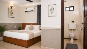 a hotel room with a bed and a toilet at DeBoss Hotel in Ikeja