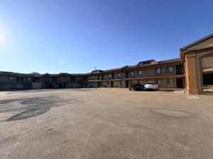 an empty parking lot in front of a building at Regal Inn Coffeyville KS US 169 in Coffeyville