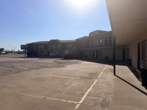 an empty parking lot in front of a building at Regal Inn Coffeyville KS US 169 in Coffeyville