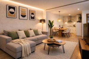 a living room with a couch and a table at Ohana Boutique Málaga Centro in Málaga