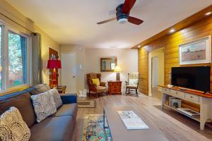 a living room with a couch and a flat screen tv at Casa Tahquitz in Idyllwild