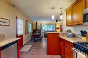 a kitchen with wooden cabinets and a dining room at Casa Tahquitz in Idyllwild