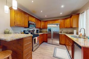 a kitchen with wooden cabinets and stainless steel appliances at Casa Tahquitz in Idyllwild
