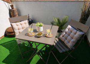 a table and chairs with drinks and food on it at El Respiro in Ruidera