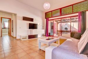 a living room with a couch and a table at Villa Malva in Corralejo