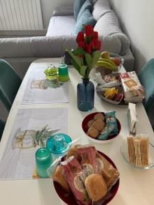 a table with plates of food and a vase of flowers at Il Nido in Castelsaraceno +10 photos