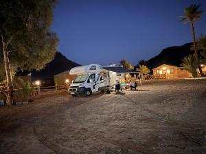 a camper parked in a yard at night at Taragalte Park - Motorhomes in Zagora