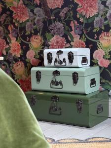 three suitcases stacked on top of each other in front of a wall at Daylily Cottage - Two Bedroom Georgian Cottage in Central Bath in Bath