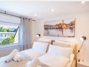 a bedroom with a bed and a large window at Zeitwohnstudios work & stay - modern, vollausgestattet für Selbstversorger in Koblenz