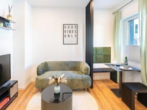 a living room with a couch and a table at Zeitwohnstudios work & stay - modern, vollausgestattet für Selbstversorger in Koblenz
