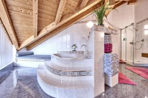 a bathroom with a sink in a room with wooden ceilings at Wally Luxus Lodge im Ferienhaus Magdalena in Mittenwald