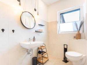 a bathroom with a sink and a toilet at Zeitwohnstudios work & stay - modern, vollausgestattet für Selbstversorger in Koblenz +34 photos