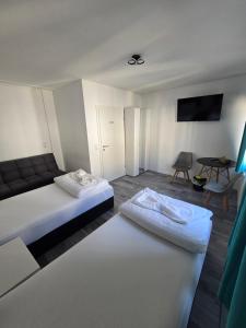a hotel room with two beds and a table at RS Zimmervermietung in Zülpich