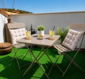 a table and two chairs with drinks on a patio at El Respiro in Ruidera