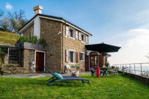 a brick house with a playground in front of it at Paradiso San Giacomo in Cogorno