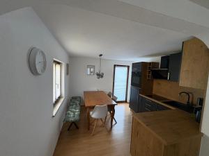 a kitchen with a table and a dining room at Bergliebe in Weitnau +18 photos