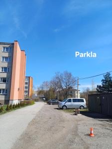 a car parked in a parking lot next to a building at Narva mnt 28 in Jõhvi