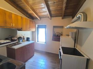 a kitchen with a sink and a refrigerator at Helidoni in Margarítai +7 photos