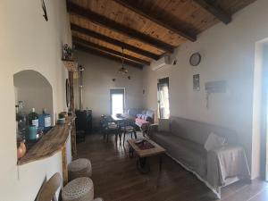 a living room with a couch and a table at Helidoni in Margarítai
