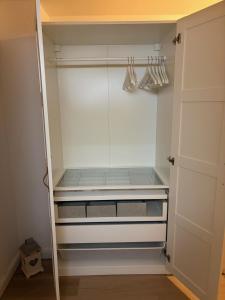 a walk in closet with white walls and glass doors at Dorfblick Barweiler in Barweiler +2 photos
