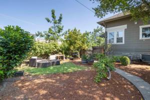 a yard with chairs and trees in front of a house at The Cooperhouse in Independence