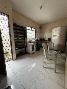 a kitchen with a table and chairs and a refrigerator at Jampa Pousada Sb in João Pessoa +18 photos