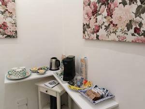 a table with a coffee maker and plates on it at Room with a view in Salerno