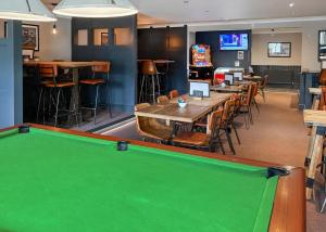 a pool table in a restaurant with a bar at Woodland Waters in Ancaster