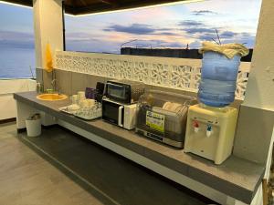 a counter with a microwave and a sink on a balcony at Hostel Asilda in San Fernando +8 photos