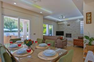 a dining room and living room with a table and chairs at Villa Calıs 2 in Fethiye