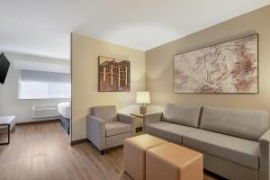 a living room with a couch and a chair at Best Western Plus Meridian in Meridian