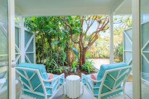 two chairs on a porch with a tree at Pavilion Hotel in Avalon