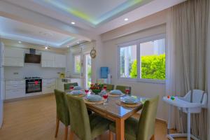 a kitchen and dining room with a table and chairs at Villa Calıs 2 in Fethiye