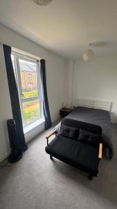 a bedroom with a bed and a large window at Blissful Abode in Birmingham
