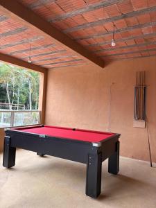 a ping pong table in a room with a ceiling at Pousada Maria elza in Eldorado