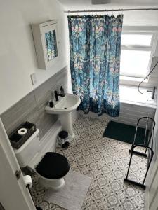 a bathroom with a toilet and a sink at The Hive 2-Bed Apartment with Kitchen and Private Bathroom in Lively Monton Village - Sleeps 4 - Free WiFi - Parking Nearby in Manchester