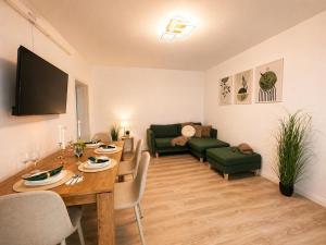 a living room with a table and a couch at Apartament Nou & Modern în Rădăuți 2 Camere Parcare WiFi in Rădăuţi