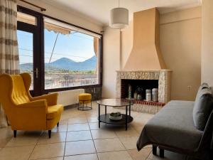 a living room with a couch and a fireplace at Lemon & Light Bright Apartment with View and Fireplace in Meligalás