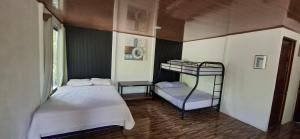 a bedroom with two bunk beds and a window at House of Dreams in Nicoya