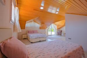 a bedroom with two beds and a wooden ceiling at Villa Calıs 2 in Fethiye +88 photos